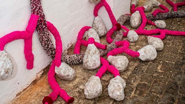 Abstract sculpture with stone and pink ribbon