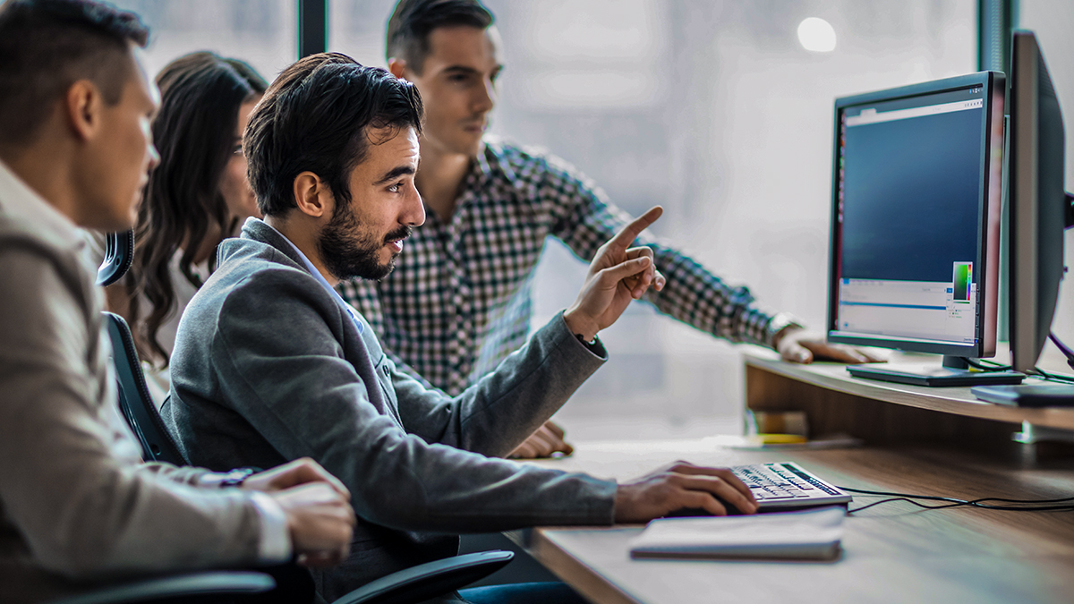 Colleagues looking at a computer screen