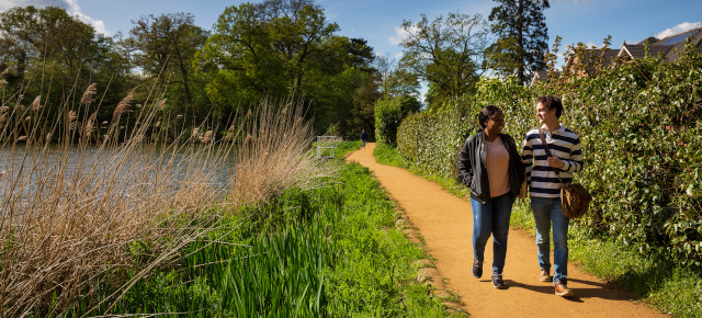 students walking by lake 